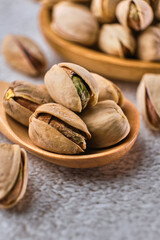 Organic pistachio nuts in bowl on table.