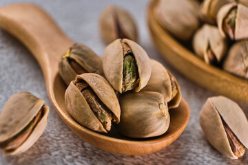 Organic pistachio nuts in bowl on table.