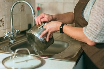 senior woman washing dishes in the kitchen