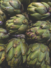 Obraz premium Fresh green Artichokes. Organic local produce vegetable. Vegan diet. Clean eating concept. Close up, top view, flat lay.