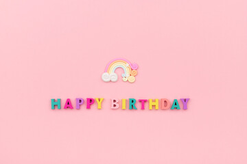 Happy birthday inscription from wooden colorful letters with rainbow
