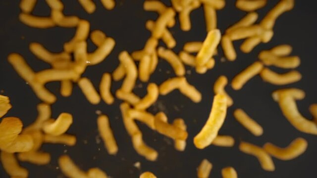 Slow motion shooting of flying nachos chips on a black background