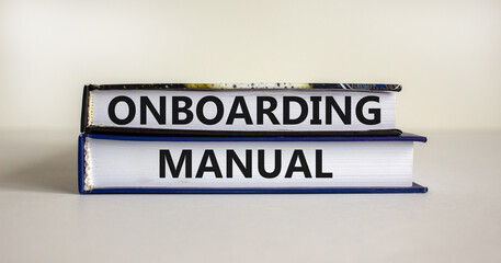 Onboarding manual symbol. Books with words 'onboarding manual' on beautiful white background. Business and onboarding manual concept. Copy space.