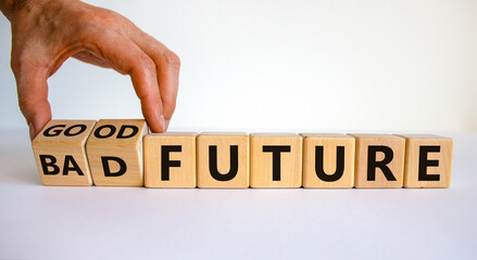 Good or bad future symbol. Businessman turns wooden cubes and changes words 'bad future' to 'good future'. Beautiful white background, copy space. Business and bad or good future concept.