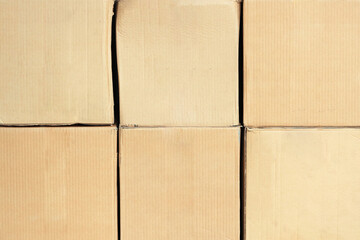 Fototapeta premium Square cardboard boxes in two rows in full screen. Front view with copy space. A blank for posting information about a logistics or transport company. Mockup