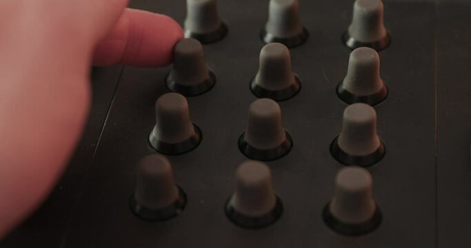 Turning knobs on a mixer board, or computer contol surface studio mixing desk panel, digital audio equipment