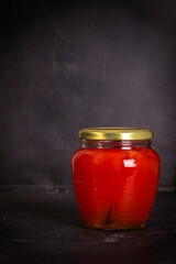 Jar of canned sweet red bell pepper made in Ukraine on black background