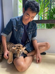 Man and baby tiger