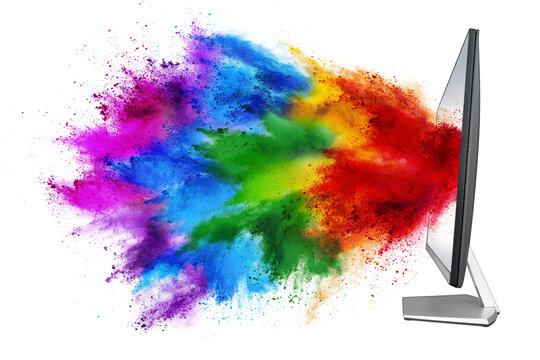 modern black silver pc computer monitor with colorful rainbow spray holi powder cloud explosion through flat screen isolated white background. multimedia abstract industry art streaming concept