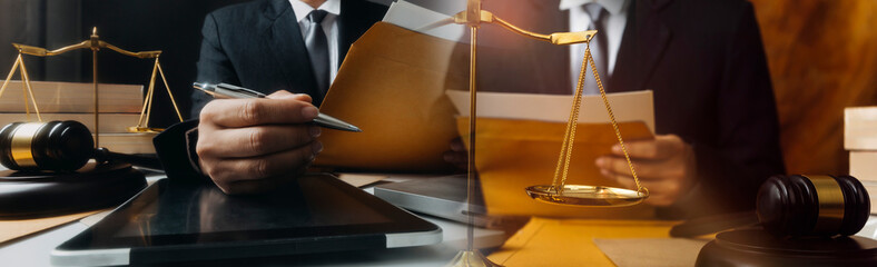 justice and law concept.Male judge in a courtroom on wooden table and Counselor or Male lawyer...