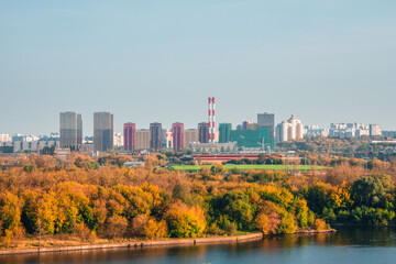 Obraz premium Residential neighborhood in an industrial area on the outskirts of Moscow. Autumn view from the hill to the city in the distance.