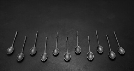 Set of coffee spoons on a black background. Food and drink concept.