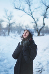 Beautiful woman enjoing winter in snowy forest.