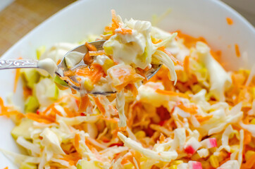Square plate of vegetable salad with mayonnaise, close-up.