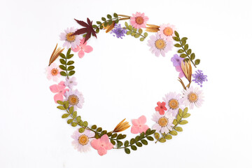 Wreath made from dry leaves and flowes on white background. Dry flowers frame. Flat lay.