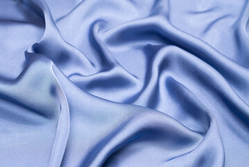Obraz premium Blue silk or satin luxury fabric texture. Top view.