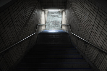 Empty dark underpass perspective. Stone stairs