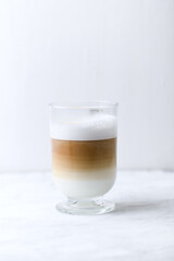 Coffee with milk on bright wooden background. Close up. Copy space. 