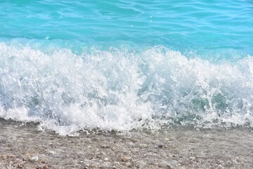 Fototapeta premium Beautiful blue lagoon with turquoise sea and wet pebble stones, with selective focus. Turquoise clean water background with natural stones. Fethie, Turkey 