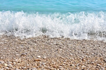 Beautiful blue lagoon with turquoise sea and wet pebble stones, with selective focus. Turquoise clean water background with natural stones. Fethie, Turkey 
