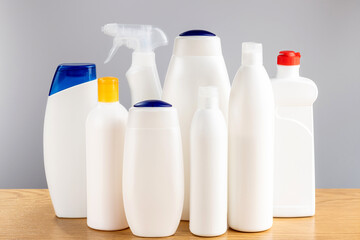 Hair and body cleansers and bathroom and window cleaners. Household chemicals on a gray background.