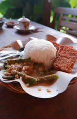 Close up of pecel rice on a wooden table. Pecel rice is a traditional food from Java, Indonesia 
