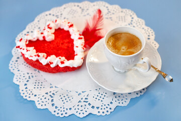 Cup of cappuccino on a white napkin decorated with heart-shaped sweets for Valentine's Day. Breakfast lovers.