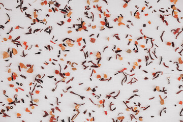 Dry fruit tea randomly scattered on a white table background. Top view. Copy, empty space for text