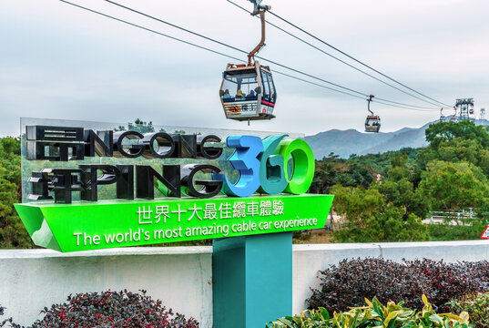Hong Kong - January 26, 2016: Ngong Ping 360 Skyrail on Lantau Island in Hong Kong is the worlds most amazing cable car experience. Big sign on cableway lift background