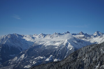 Fototapeta na wymiar Scenic View Of Snowcapped Mountains Against Blue Sky