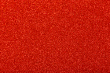 Sparkle glowing red glitter of carborundum abstract textured background