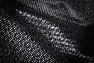 Fototapeta na wymiar Close up of Black wavy fabric abstract background.
