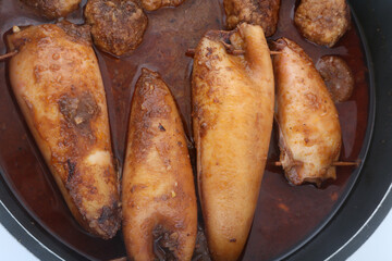stuffed squid cooked with sauce and meat balls
