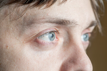 light gray-blue eye looks away. Close-up