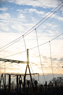 High-power electricity transmission station at sunset with an installed lightning protection system.