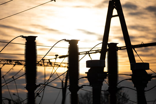 High-power electricity transmission station at sunset with an installed lightning protection system.
