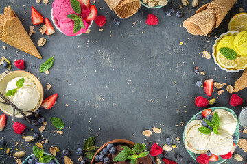 
Various colorful ice cream balls in different bowls, with ice cream waffles cones and flavor ingredients - pistachio nuts, berries, lemon, chocolates, vanilla beans, mint. Dark background copy space
