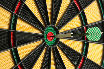 Darts target game. Close up image of dartboard with dart arrow hitting the center. Marketing and...