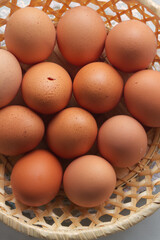 An egg in the basket stands out because it is beginning to open.
