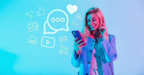 Happy pretty young fashionable girl holding a mobile phone and communicating in social networks with icons. Internet communication concept