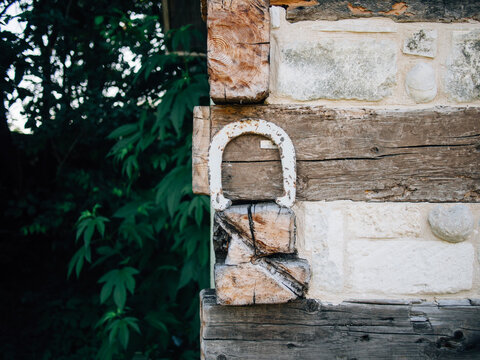 Old vintage horseshoe leaning against building