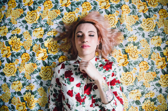 woman lying on a floral pattern