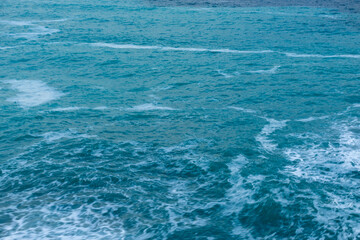 beautiful, blue sea with waves, foam on a nice, warm day in the tropics travel, vacation, walk