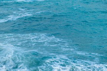 beautiful, blue sea with waves, foam on a nice, warm day in the tropics travel, vacation, walk