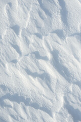 Fresh clean white snow background texture. Winter background with frozen snowflakes and snow mounds. Snow lumps. Seasonal landscape details. Cold weather.