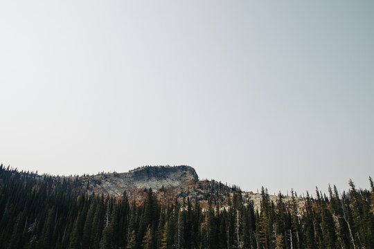 Rocky mountain peak in Idaho's Selkirk range, underneath a clear evening sky.
