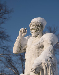 Snowy statue in a park on the Drottningholm island in Stockholm a winter day
