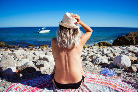 Portrait of relaxed woman sunbathing in a paradisiac cove
