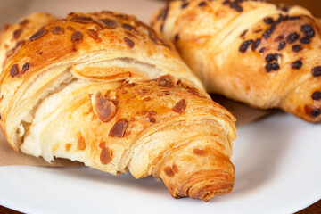 set of fresh baked croissants on wooden table. French croissant.