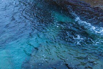 Obraz premium beautiful, blue sea with waves, beach, rocks in the evening on a nice, warm evening in travel